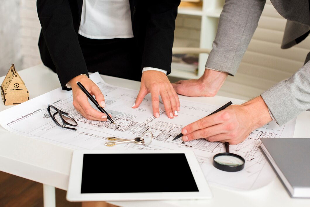 architects-studying-plan-with-mockup_23-2148252110